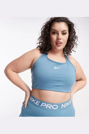 Nike Pro Training - Brassière de sport asymétrique maintien moyen en tissu  Dri-FIT avec logo virgule - Noir