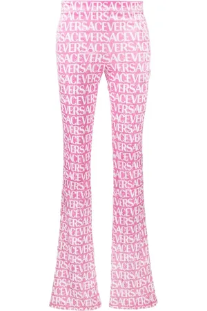 VERSACE Pantalon évasé à logo imprimé