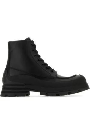 Alexander McQueen Combat boots en cuir à logo embossé