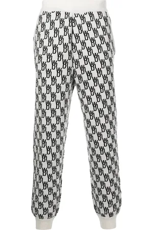 We11 Done Pantalon de jogging en maille intarsia à motif monogrammé