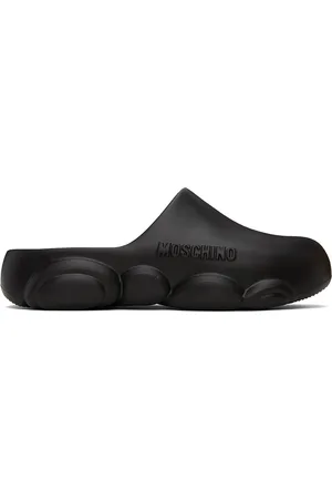 Moschino Chaussures à enfiler noires en caoutchouc à semelle en forme d