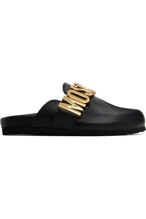 Moschino Mules noires à ferrures à logo surdimensionnées