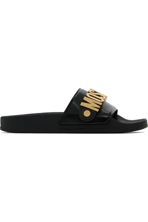 Moschino Sandales à enfiler noires à ferrures à logo