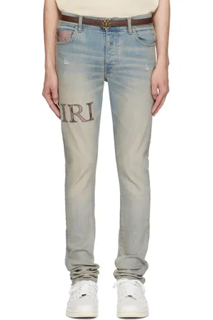 AMIRI Jean skinny bleu à logo et garniture gaufrée façon serpent