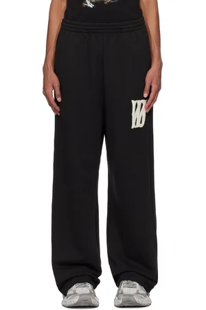 We11 Done Pantalon de survêtement noir à logo en bouclé