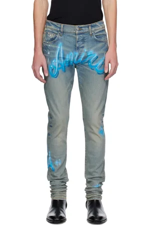 AMIRI Jean skinny bleu à logos à effet aérosol