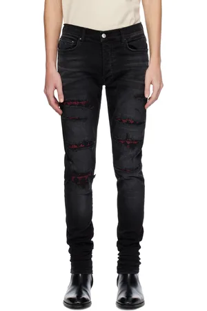 AMIRI Jean skinny noir à effet usé et à quadrigrammes