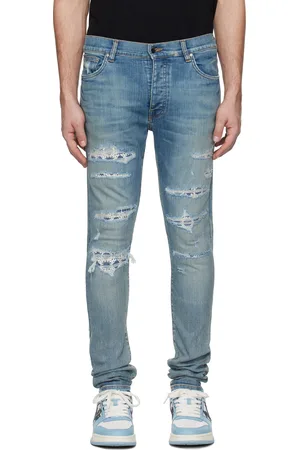 AMIRI Jean skinny bleu à empiècements à quadrigrammes