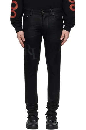 AMIRI Jean skinny noir en denim ciré à logo étagé