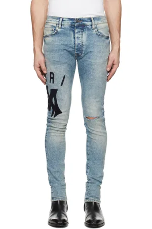 AMIRI Jean skinny bleu à appliqués à logo en suède