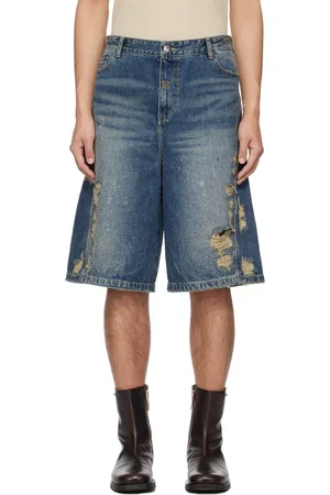 lesugiatelier Short bleu en denim à déchirures et à ornements facettés
