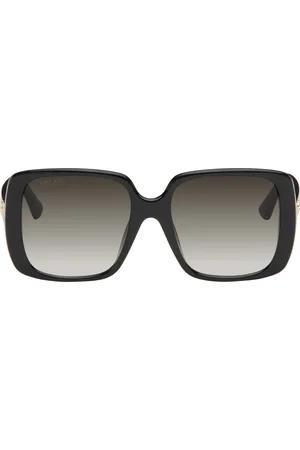 Gucci Lunettes de soleil noires à branches à rayures et à logo GG