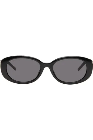 Gucci Lunettes de soleil ovales noires à ferrures à logo G