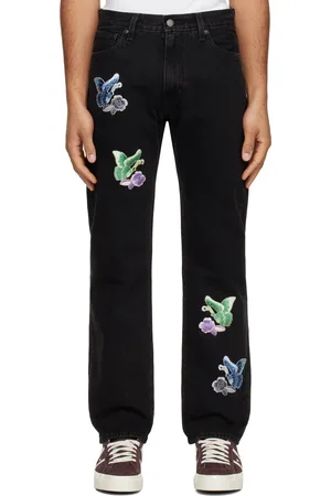 Anna Sui Jean noir à appliqués graphiques et à effet délavé