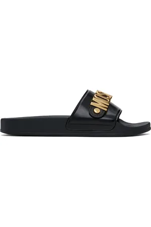 Moschino Sandales à enfiler noires à ferrures à logo