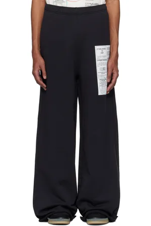 Maison Margiela Pantalon de survêtement noir à imprimé de journal