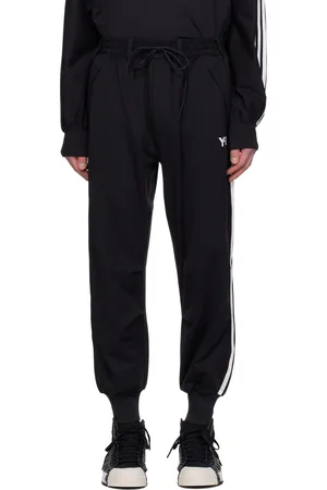 Y-3 Pantalon de survêtement noir à trois rayures et à revers en tricot côtelé