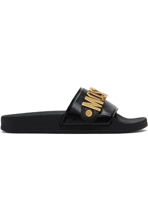 Moschino Sandales à enfiler noires à ferrures à logo