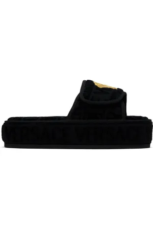 VERSACE Pantoufles noires à motif à logos