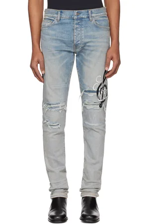 AMIRI Jean skinny bleu à monogrammes à note de musique