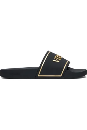 VERSACE Sandales à enfiler noir et doré à logo