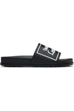 VERSACE Sandales à enfiler Shelly noires à logo