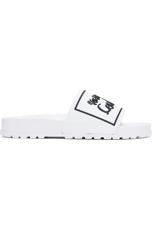 VERSACE Sandales à enfiler Shelly blanches à logos