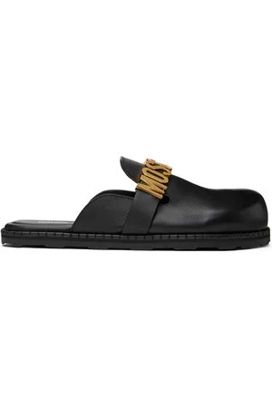 Moschino Flâneurs de style mule noirs en cuir