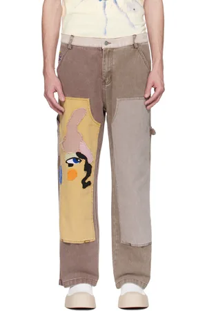 KIDSUPER STUDIOS Pantalon brun à appliqués en forme de visage et à empiècement aux genoux