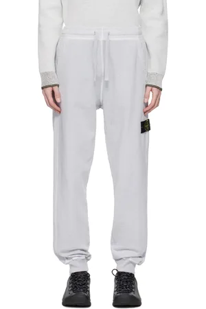 Stone Island Pantalon de survêtement gris en coton à fil irrégulier et à effet vieilli emblématique