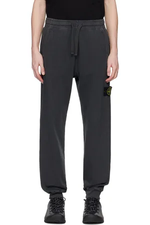 Stone Island Pantalon de survêtement gris en coton à fil irrégulier et à effet vieilli emblématique