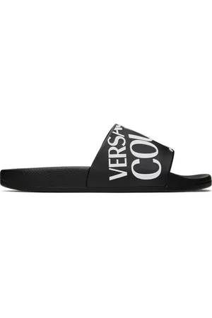 VERSACE Sandales à enfiler noires à logo gaufré