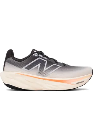 New Balance Baskets 1080v14 noir et beige à semelle intercalaire en Fresh Foam X